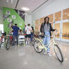 Temple student standing with a yellow bike that she just purchased at the Secondhand bike sale.