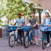 Three students riding Indego bikeshare bikes.