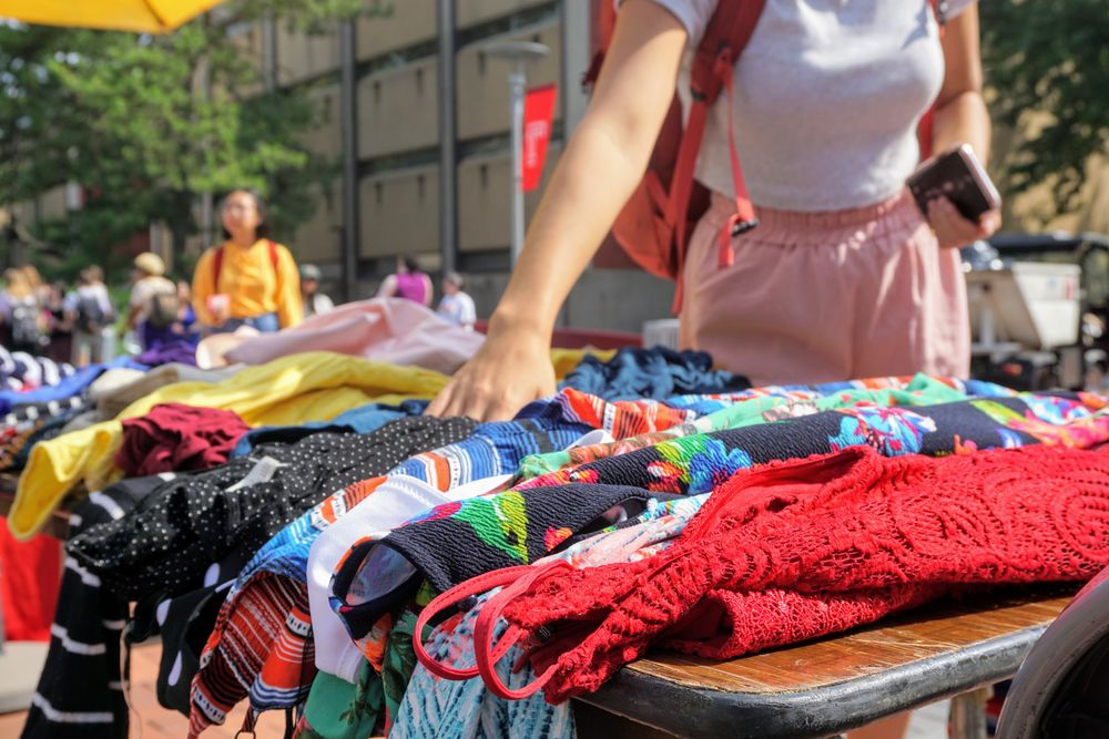 Picture of Temple Thrift, colorful garments displayed on table.